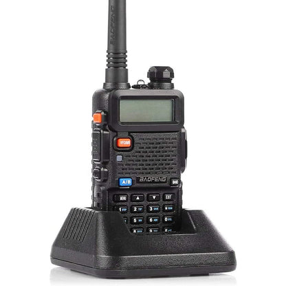 Baofeng UV-5R in black sitting in its charging cradle